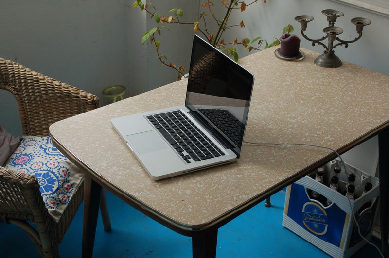 A single laptop on a table — the sending device