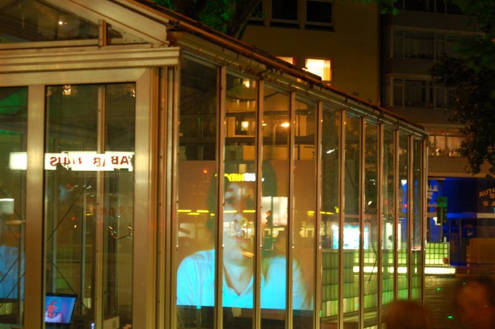 Düsseldorf 2008 — the webcam face projected inside the glass pavilion at night