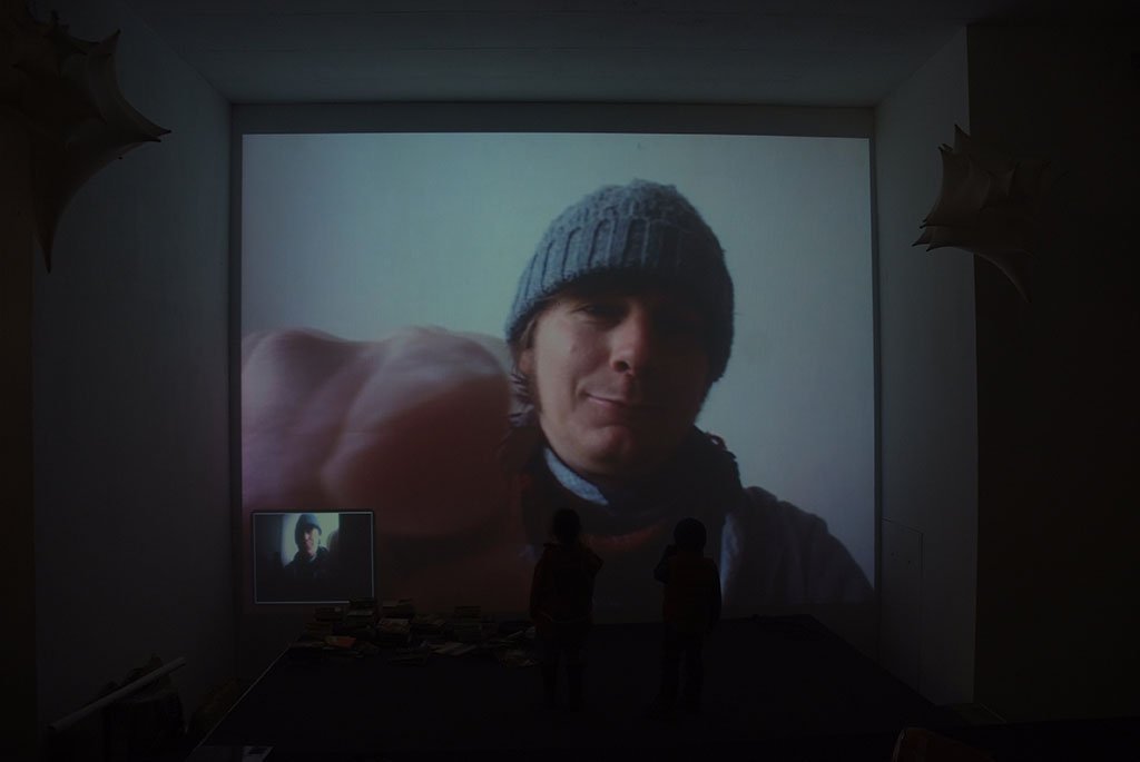 Leipzig 2010 — the face projected large in a white room, a small viewer before it